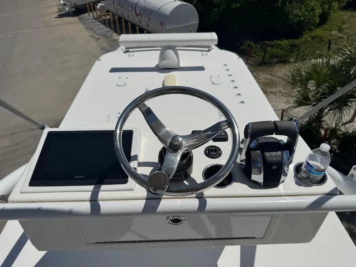  Yacht Photos Pics Invincible 46 Catamaran 2022 helm with steering wheel, controls, and navigation screen.