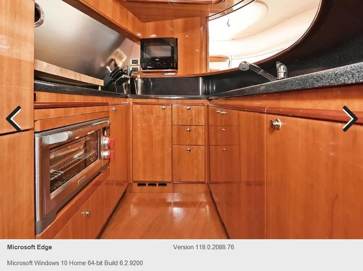  Yacht Photos Pics Luxurious kitchen interior of 2005 Azimut 68E yacht with wooden cabinetry and modern appliances.