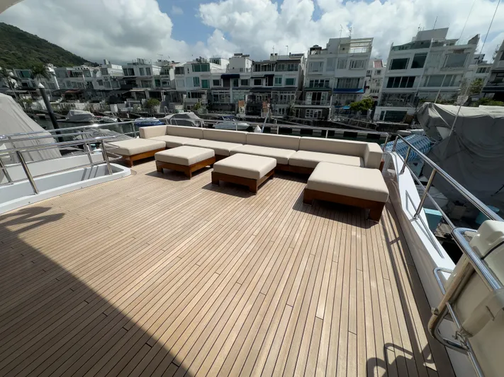  Yacht Photos Pics Luxurious 2016 Azimut 100 Grande yacht deck with modern seating and scenic marina view.