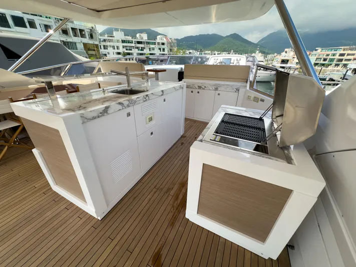  Yacht Photos Pics Luxurious outdoor kitchen on 2016 Azimut 100 Grande yacht with grill and marble countertops.