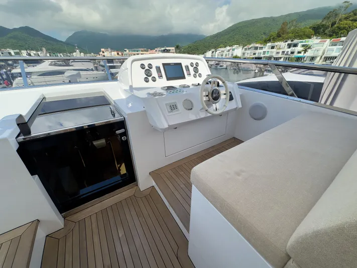  Yacht Photos Pics Flybridge of 2016 Azimut 100 Grande yacht with helm station and seating area.