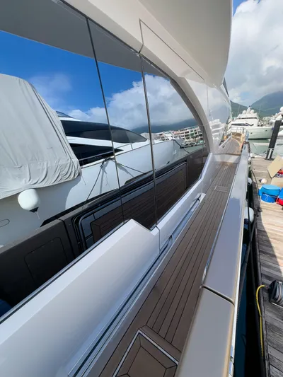  Yacht Photos Pics 2016 Azimut 100 Grande yacht docked, reflecting blue sky and clouds.