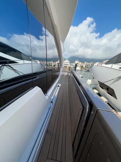  Yacht Photos Pics Side view of 2016 Azimut 100 Grande yacht docked at marina under blue sky.