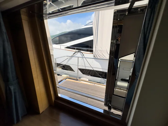  Yacht Photos Pics View from inside a 2016 Azimut 100 Grande yacht, showing exterior and dock.