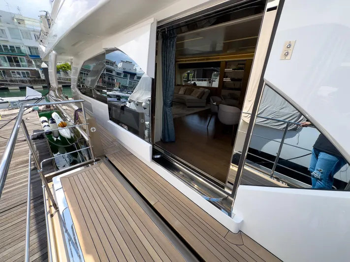  Yacht Photos Pics Luxury Azimut 100 Grande yacht deck with open sliding door, revealing elegant interior.
