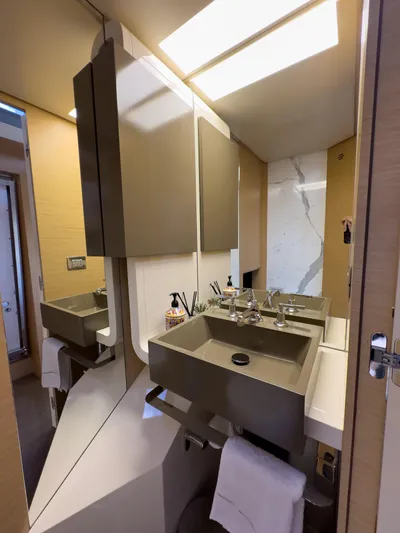  Yacht Photos Pics Luxurious bathroom in 2016 Azimut 100 Grande yacht with modern sink and elegant fixtures.