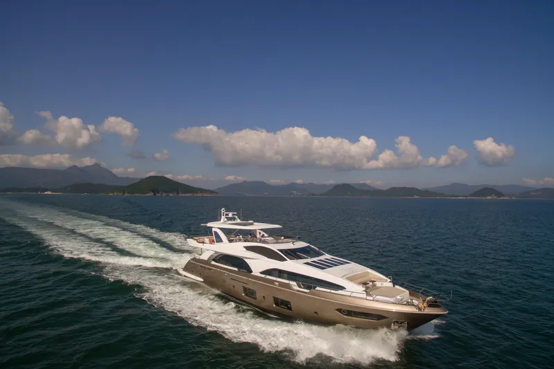  Yacht Photos Pics Luxury yacht Azimut 100 Grande 2016 cruising on open sea under clear blue sky.