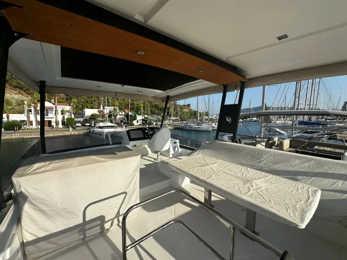  Yacht Photos Pics 2022 Fountaine Pajot MY5 yacht interior with marina view, featuring modern seating and helm.