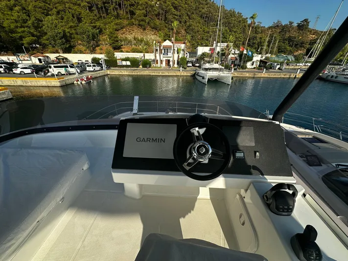  Yacht Photos Pics Helm of 2022 Fountaine Pajot MY5 yacht with Garmin navigation, docked in scenic marina.