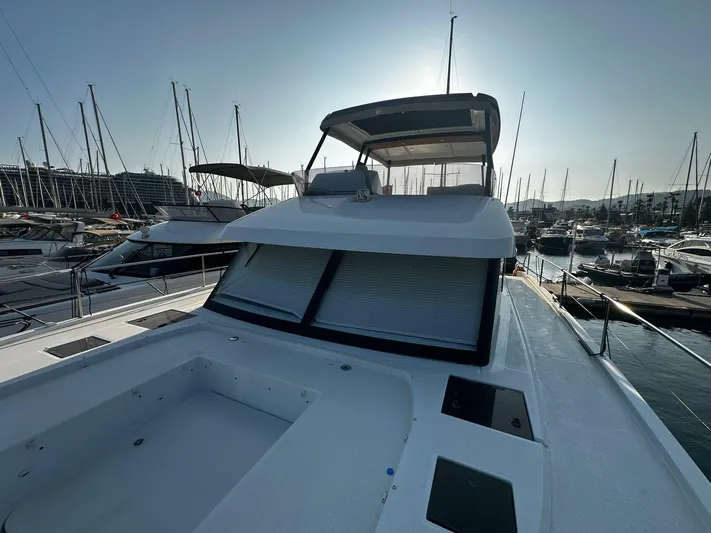  Yacht Photos Pics 2022 Fountaine Pajot MY5 yacht docked in marina, showcasing sleek design and spacious deck.
