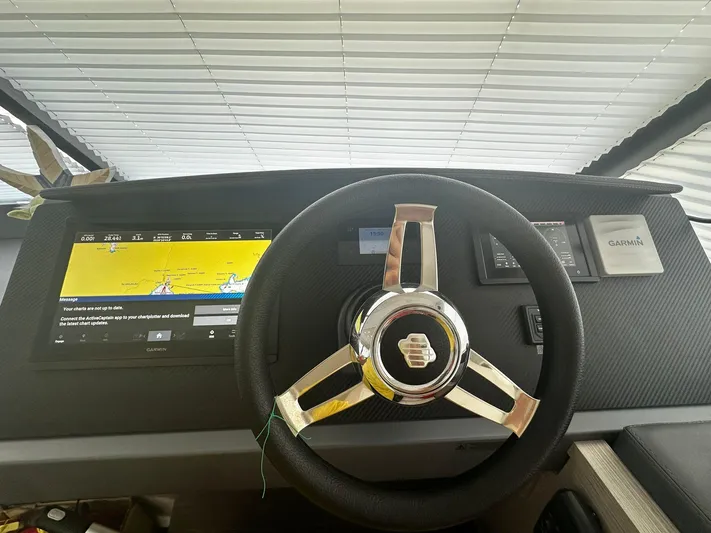  Yacht Photos Pics Steering wheel and dashboard of 2022 Fountaine Pajot MY5 yacht with navigation display.