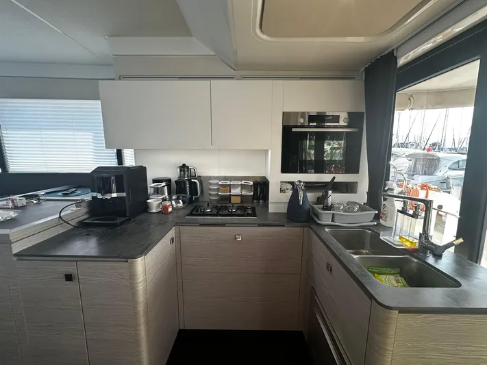  Yacht Photos Pics Modern kitchen interior of 2022 Fountaine Pajot MY5 yacht with appliances and sleek design.