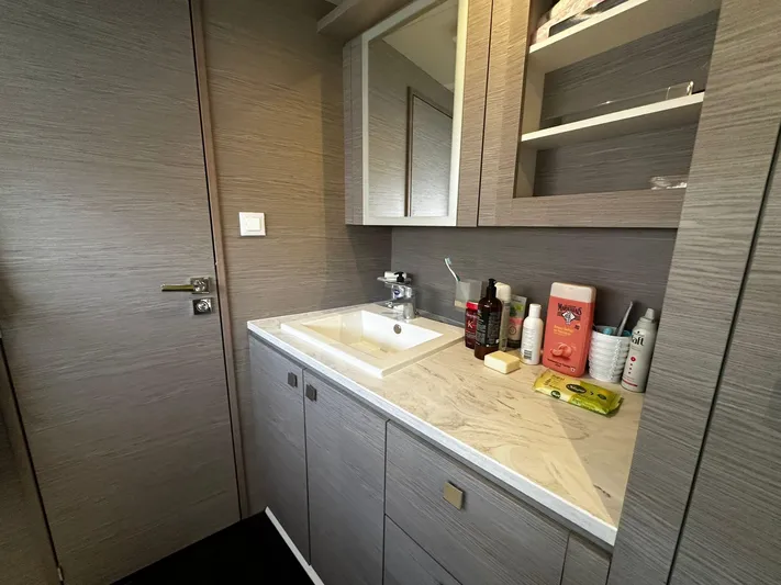  Yacht Photos Pics Modern bathroom interior on a 2022 Fountaine Pajot MY5 yacht, featuring a sleek sink and storage.