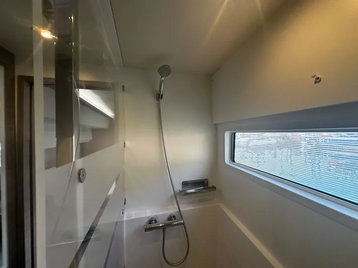  Yacht Photos Pics Modern shower area in 2022 Fountaine Pajot MY5 yacht with sleek design and window view.