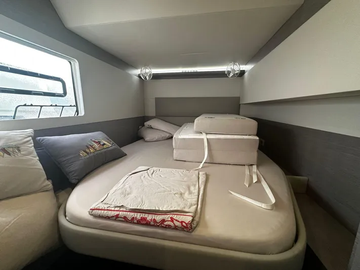  Yacht Photos Pics 2022 Fountaine Pajot MY5 cabin interior with bed, cushions, and window view.