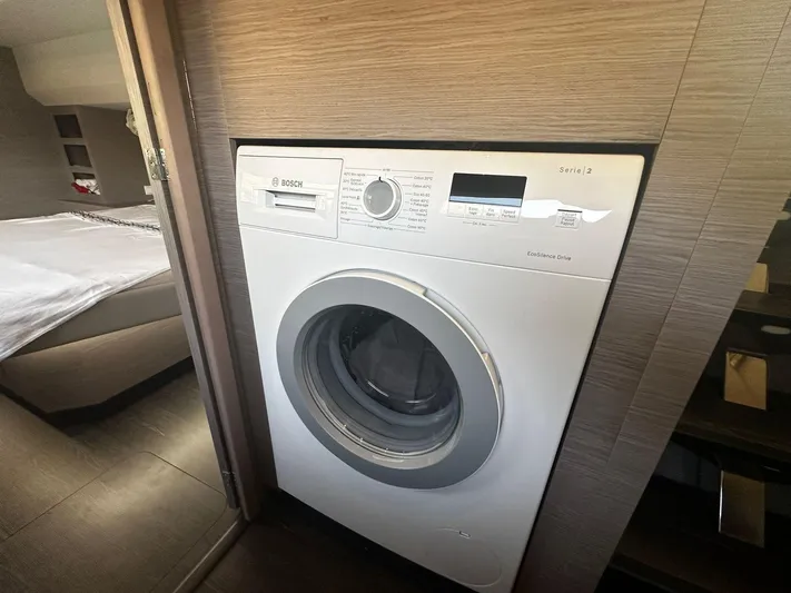  Yacht Photos Pics Washing machine in 2022 Fountaine Pajot MY5 yacht interior, near bedroom area.