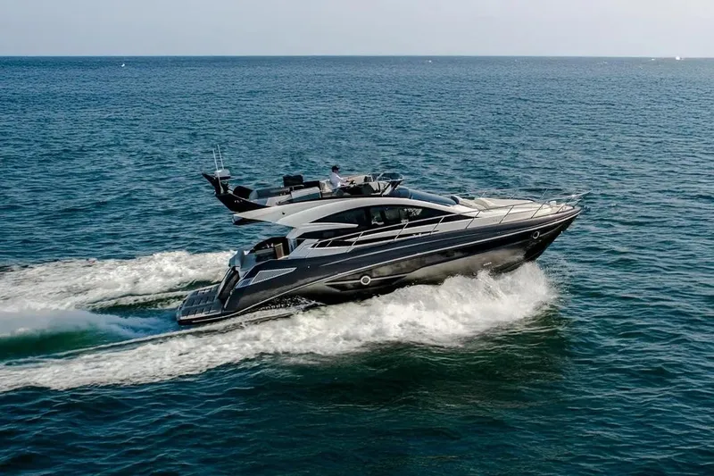  Yacht Photos Pics 2025 Cobrey 52 FLY yacht cruising on open sea, showcasing sleek design and performance.