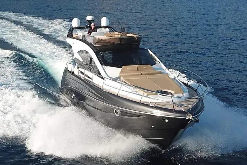  Yacht Photos Pics 2025 Cobrey 52 FLY yacht cruising on open water, showcasing sleek design and luxury features.