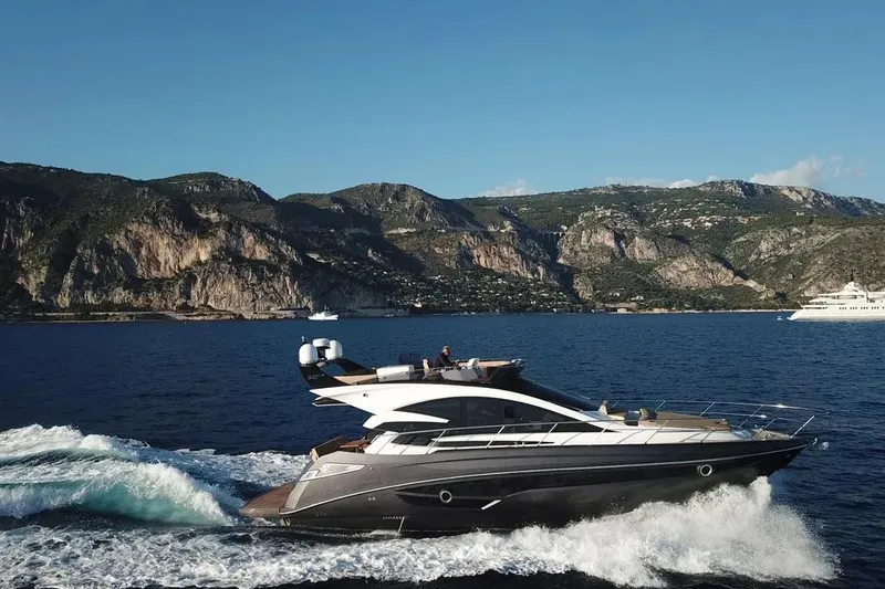  Yacht Photos Pics 2025 Cobrey 52 FLY yacht cruising on scenic coastal waters.