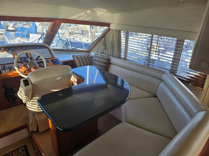 Third Wish Yacht Photos Pics Interior of a 2005 Navigator 44C yacht with helm and seating area.