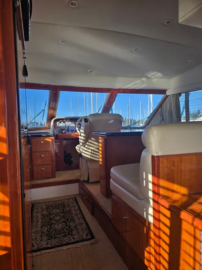 Third Wish Yacht Photos Pics Interior of a 2005 Navigator 44C yacht with wooden furnishings and cushioned seating.