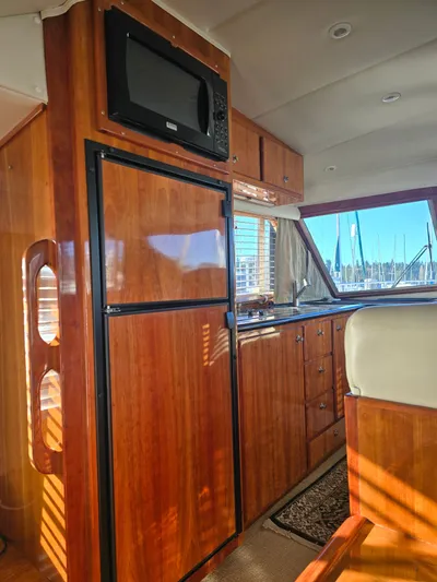 Third Wish Yacht Photos Pics Interior of 2005 Navigator 44C yacht with wooden cabinetry and appliances.