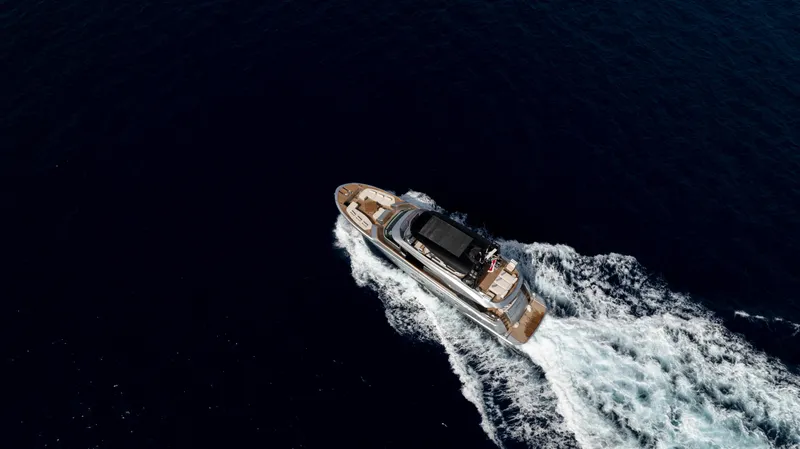 Venus Yacht Photos Pics Aerial view of 2013 Monte Carlo Yachts 86'7'' cruising on deep blue ocean.