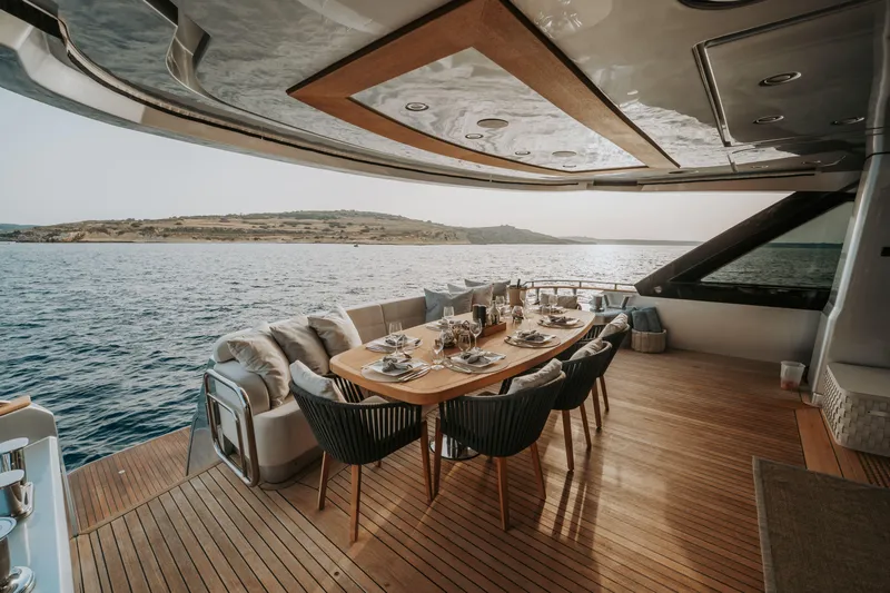 Venus Yacht Photos Pics Luxurious dining area on a 2013 Monte Carlo Yachts 86'7'' yacht, overlooking serene ocean views.