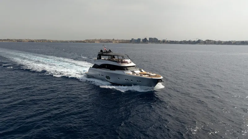 Venus Yacht Photos Pics Luxurious 2013 Monte Carlo Yachts 86'7'' cruising on open sea near coastline.