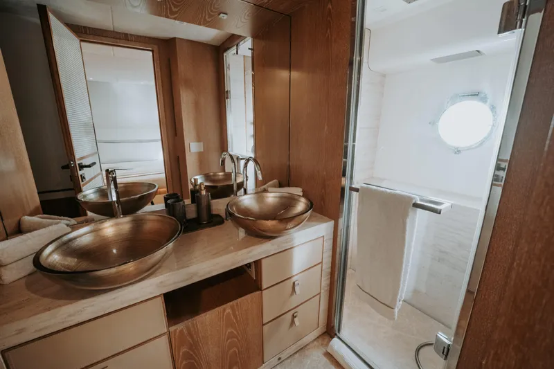 Venus Yacht Photos Pics Luxurious bathroom on 2013 Monte Carlo Yachts 86'7'', featuring elegant vessel sinks and modern shower.