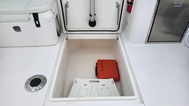 Yacht Photos Pics Edgewater 280 CX 2023 boat storage compartment with orange Kessel case.