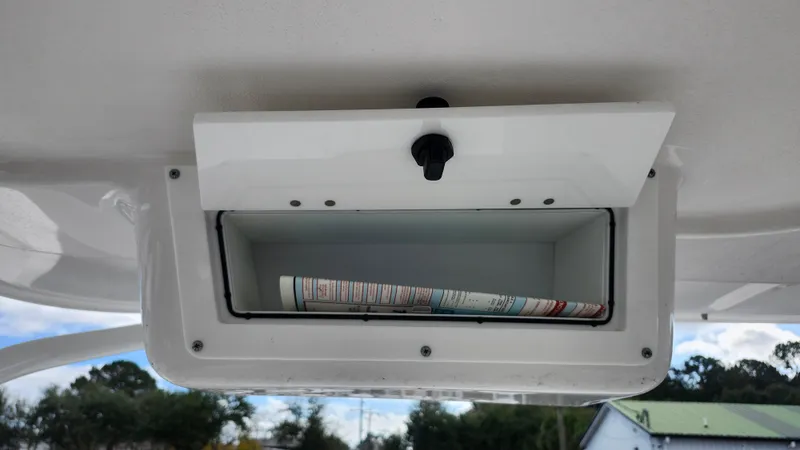  Yacht Photos Pics Edgewater 280 CX 2023 storage compartment with rolled-up map inside.