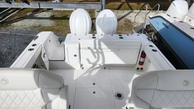  Yacht Photos Pics 2023 Edgewater 280 CX boat interior with white seating and dual engines.