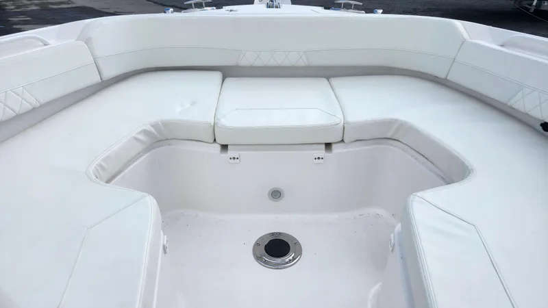  Yacht Photos Pics Edgewater 280 CX 2023 boat interior with white cushioned seating.