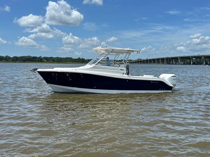  Yacht Photos Pics 2023 Edgewater 280 CX boat on calm water under a blue sky.