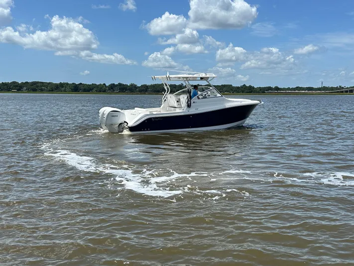  Yacht Photos Pics 2023 Edgewater 280 CX boat cruising on a sunny day with clear skies.