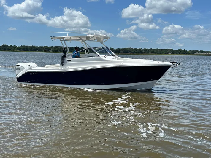  Yacht Photos Pics 2023 Edgewater 280 CX boat cruising on a sunny day with clear skies.