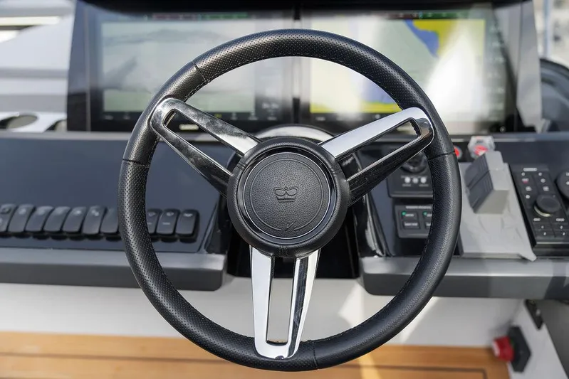 V50330 Yacht Photos Pics Steering wheel of 2024 Princess V50 Open yacht with modern dashboard controls.