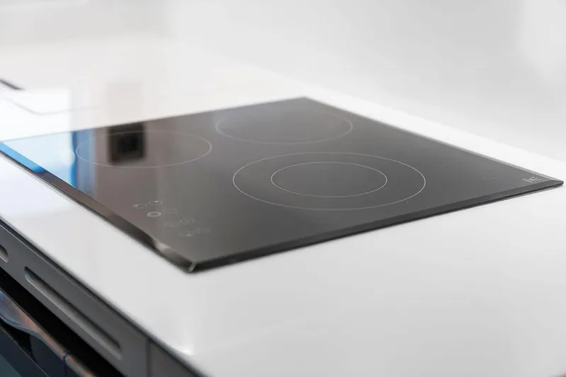 V50330 Yacht Photos Pics Sleek modern stovetop on 2024 Princess V50 Open yacht kitchen.