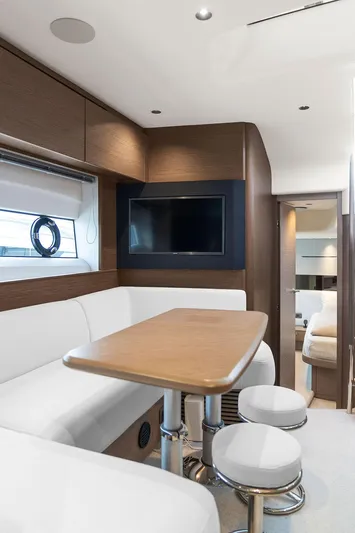 V50330 Yacht Photos Pics 2024 Princess V50 Open yacht interior with modern seating, table, and TV.