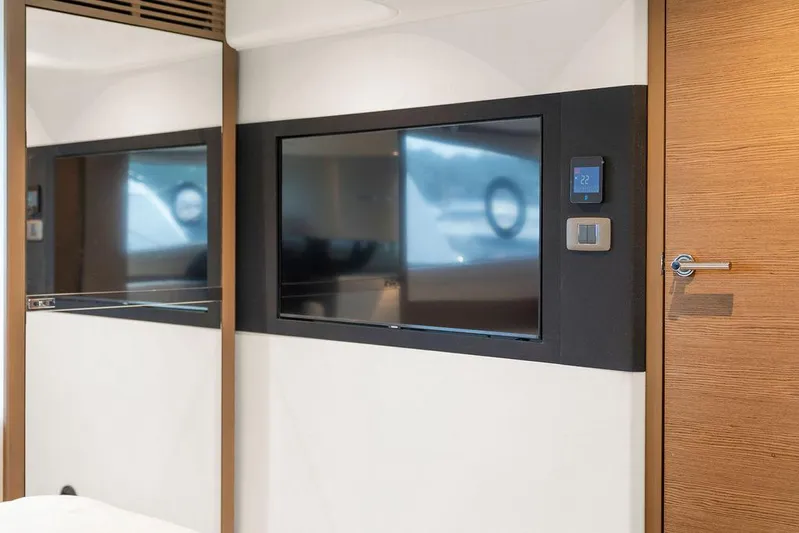 V50330 Yacht Photos Pics 2024 Princess V50 Open yacht interior with modern TV and wooden accents.