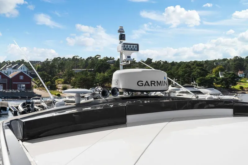 V50330 Yacht Photos Pics 2024 Princess V50 Open yacht with Garmin radar, docked near scenic shoreline.