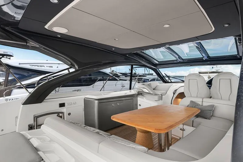 V50330 Yacht Photos Pics 2024 Princess V50 Open yacht interior with luxurious seating and wooden table.