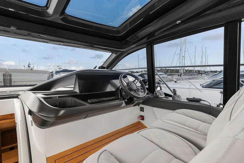 V50330 Yacht Photos Pics 2024 Princess V50 Open yacht cockpit with luxurious seating and modern steering wheel.