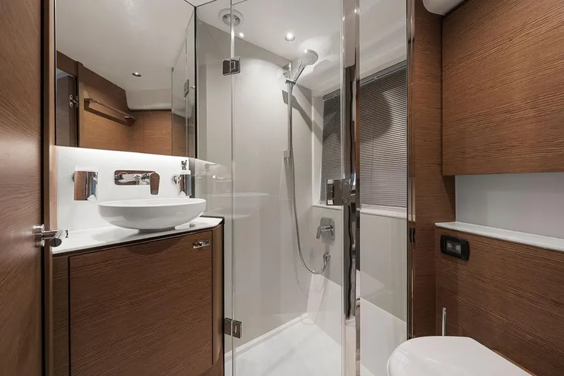 V50330 Yacht Photos Pics Luxurious bathroom in 2024 Princess V50 Open yacht with modern fixtures and wooden cabinetry.