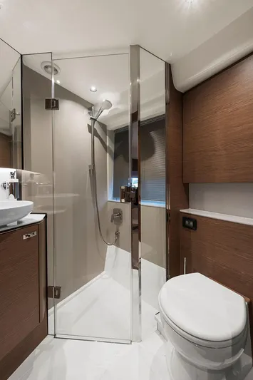 V50330 Yacht Photos Pics Luxurious bathroom in 2024 Princess V50 Open yacht with modern shower and wooden accents.