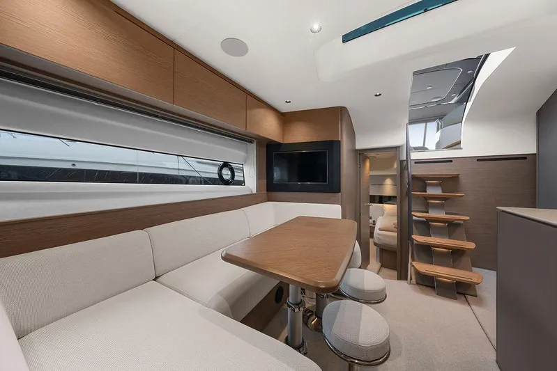 V50330 Yacht Photos Pics Luxurious interior of 2024 Princess V50 Open yacht with modern seating and wooden accents.