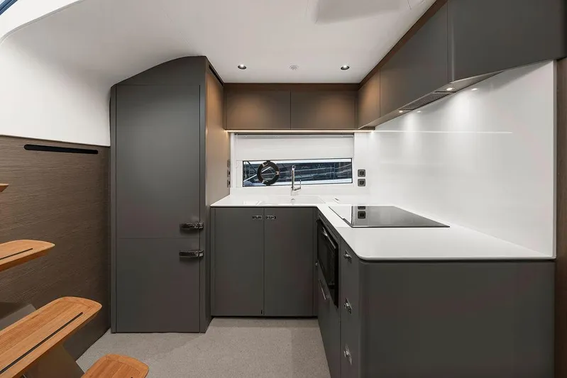 V50330 Yacht Photos Pics Modern kitchen interior of 2024 Princess V50 Open yacht, featuring sleek cabinetry and appliances.