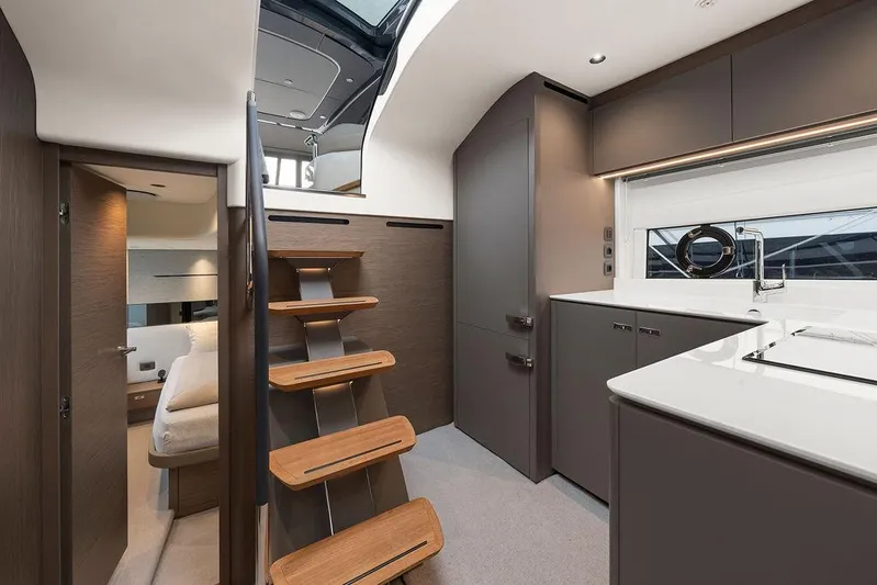 V50330 Yacht Photos Pics 2024 Princess V50 Open yacht interior with modern kitchen and wooden stairs.