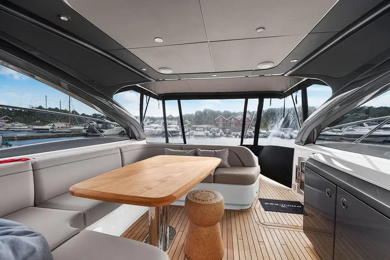 V50330 Yacht Photos Pics Luxurious interior of 2024 Princess V50 Open yacht with elegant seating and wooden table.